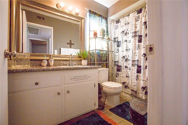 Super clean, bathroom, with travel inspired decor.
