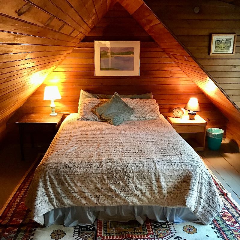 This is the bedroom, which has a queen size bed. The original tongue and groove walls are the cozy style of this late 19th Century cottage. The entire cottage walls and ceilings were insulated four years ago.
The entire property was bought by the Evarts from the original farmer, Ebenezer Pike, who began here in 1766. When the Pikes left Cornish for the Case Western Reserve in Ohio (where growing conditions and seasons were better) in 1875, patriarch William Maxwell Evarts bought the property into the family. This cottage and its dwellings are original to the Cornish Arts Colony, begun in 1885 by my late husband's Great Aunt and Uncle, Charles and Hettie Evarts Beaman, when they inherited the Colony properties from her father as a wedding gift.