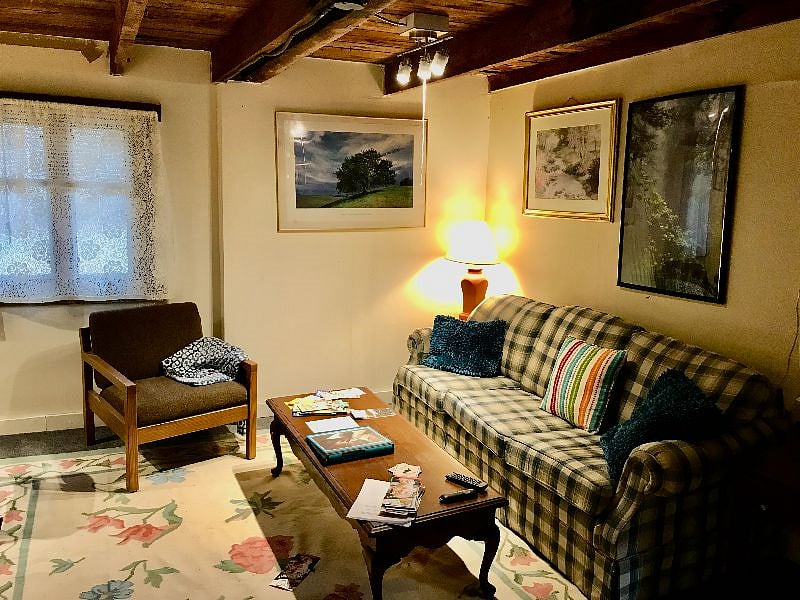 The living room has exposed beams from 1888 and 1766! All the electric and plumbing are updated. The living room has track lighting as well as traditional lighting.
