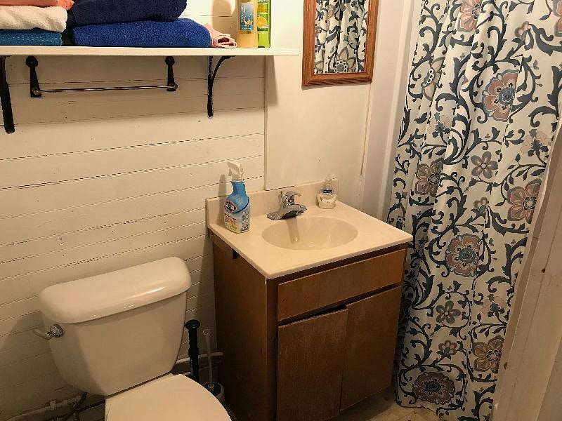 The bathroom has an oversize shower with two seats built in.