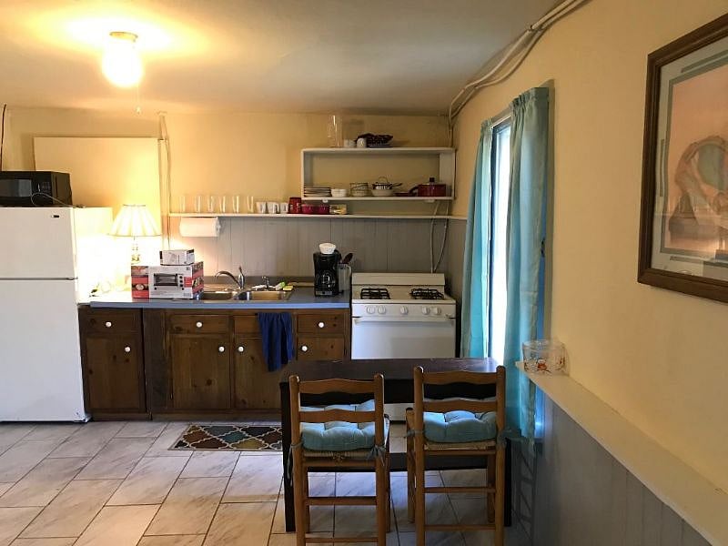 You enter the apartment in the kitchen/living room/desk areas; the front door is to the left of this photo. Appliances are full size. The built-in desk has shelves along both sides of the desk. There is hi-speed internet throughout the cottage.