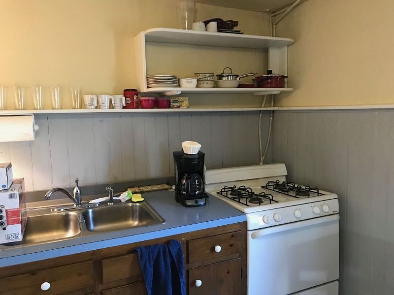 Sink, stove/oven, dish storage in the above photo. Pots and pans are in the cabinet below the counter, and silverware is in the drawer of the dining table.