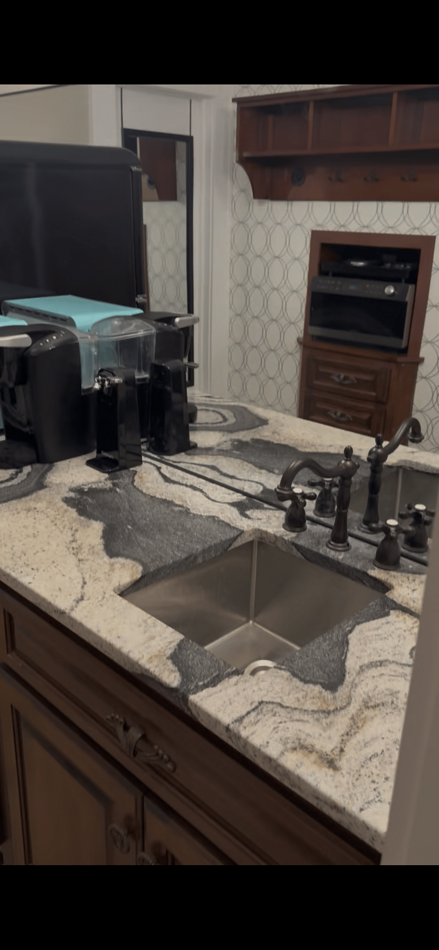 Kitchenette includes sink, refrigerator, Keurig, microwave/toaster oven/air fryer combination, cooktop, utensils, some dishes.