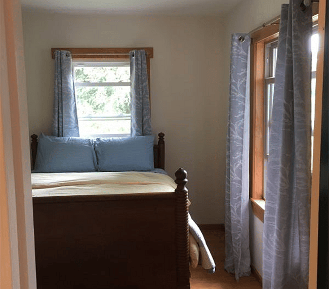 Bedroom with new queen-size mattress and antique oak bed