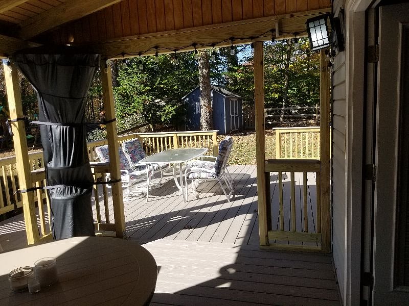Patio table, chairs, grill, the community pool is just behind the fence.