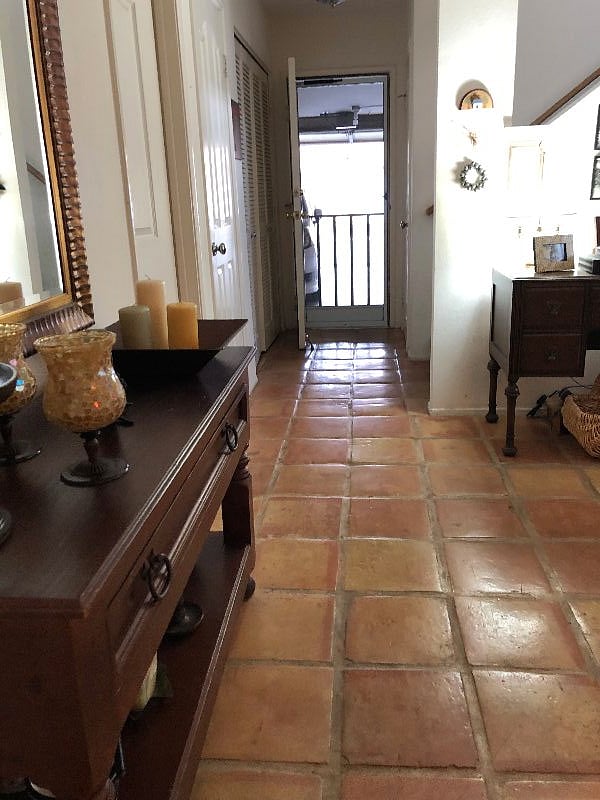 Interior Cozy Condo lower floor sitting area - treadmill - tv- fridge - desk - door into garage