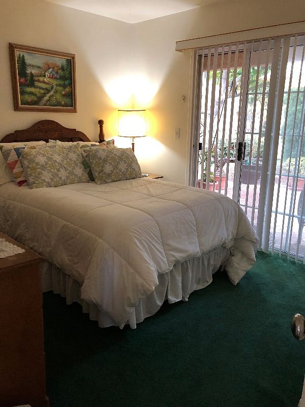 Interior Cozy Condo bedroom / full bed - sliding glass door to gated patio