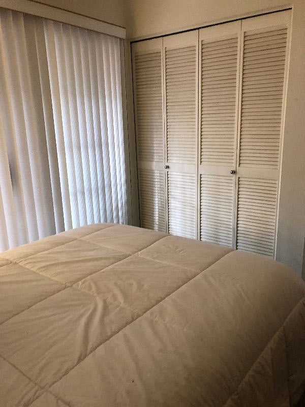 Interior Cozy Condo bedroom / full bed - wall closet
