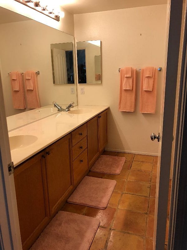 Interior Cozy Condo bathroom - double sinks - storage cabinets