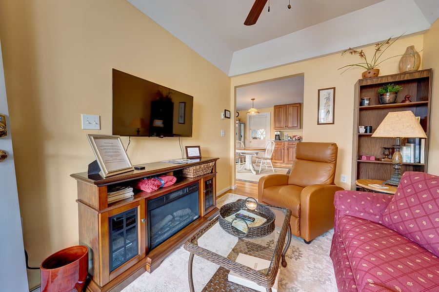 Cozy living area open to kitchen. Love seat along with chair. Electric fireplace. Nicely appointed.