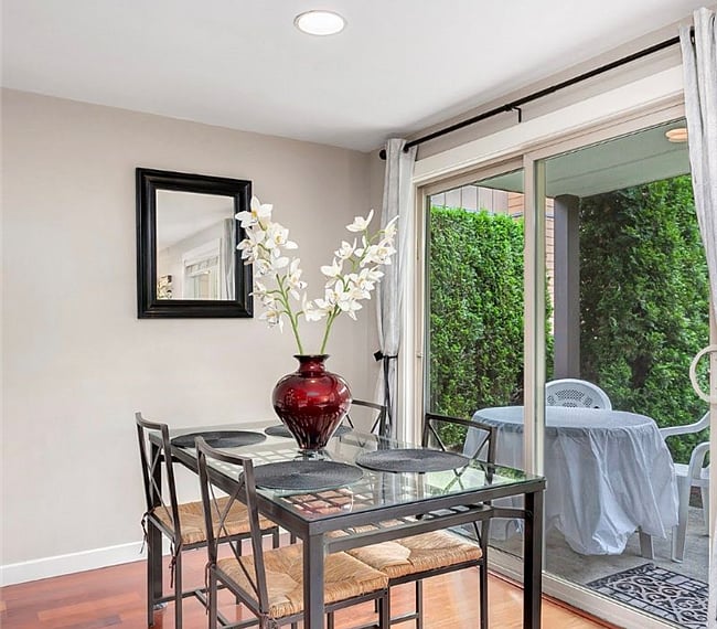 Dining Area with 4 piece glass dining table and seating with adjoining slider patio to outside