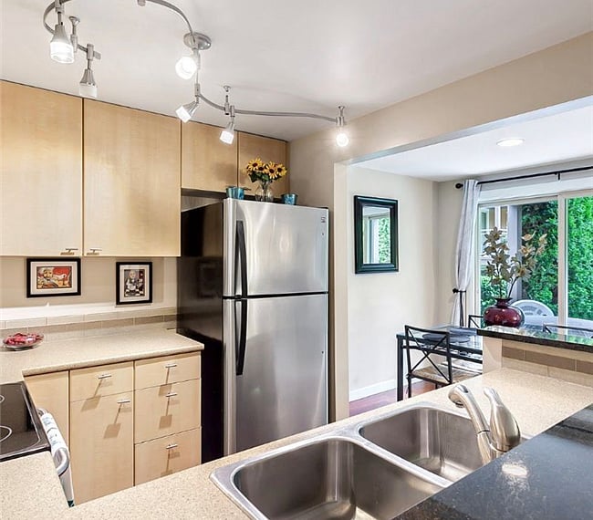 Stainless Steel Appliances in Kitchen with gorgeous track lighting