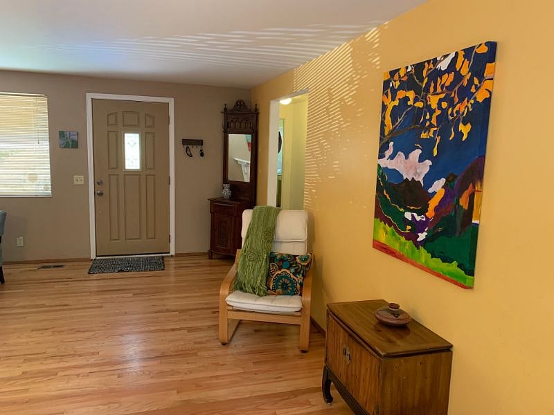 Cozy reading nook with bright artwork. 