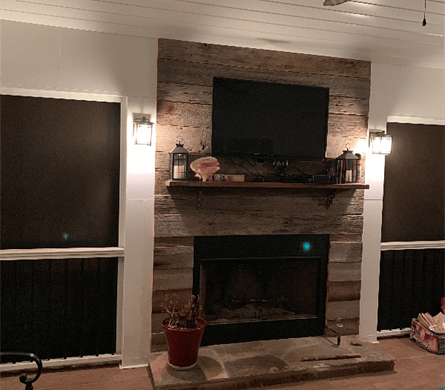 Screened Porch with fireplace/television at night