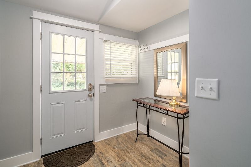 Rear Foyer leads to fenced back yard, hot tub, grill and covered porch with picnic table