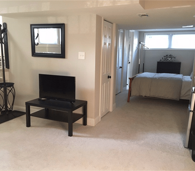 Living area looking into bedroom - natural light. Update - space now includes a 53" LG smart television.