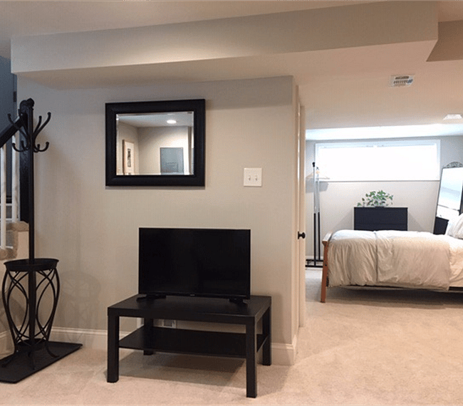 Living area looking into bedroom. Update - space now includes a 53" LG smart television.