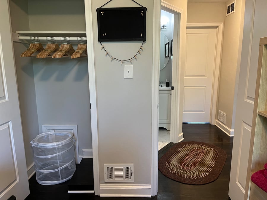 View into hallway, shared bathroom, and owner's room.