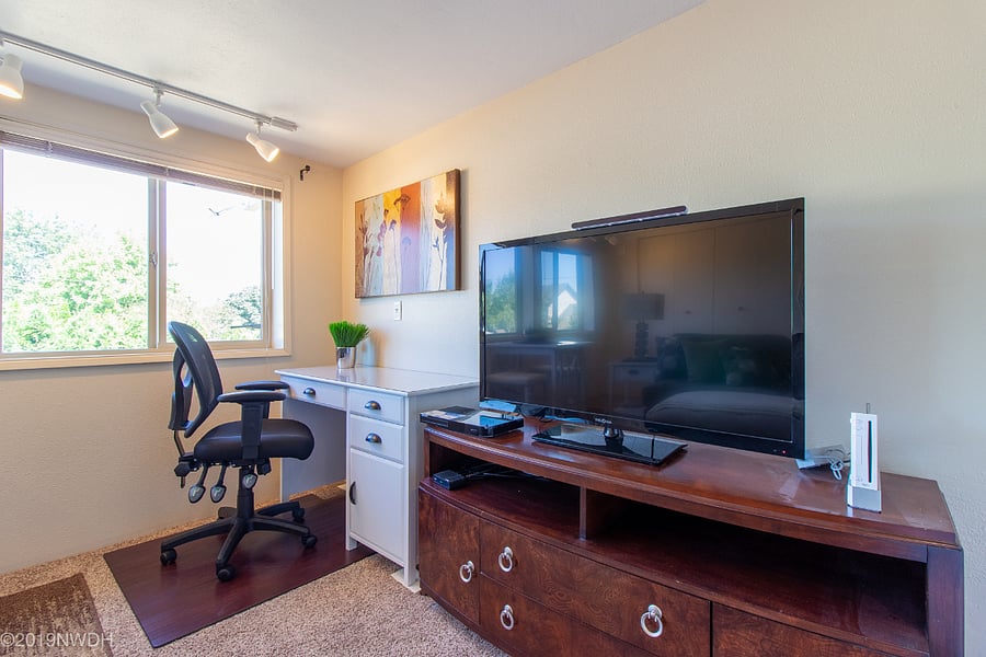 Next to TV is desk area