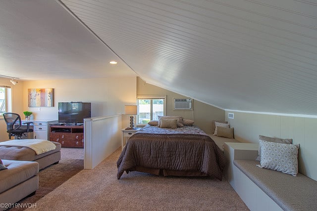 Bedroom area is separated from living room by 1/2 wall divider