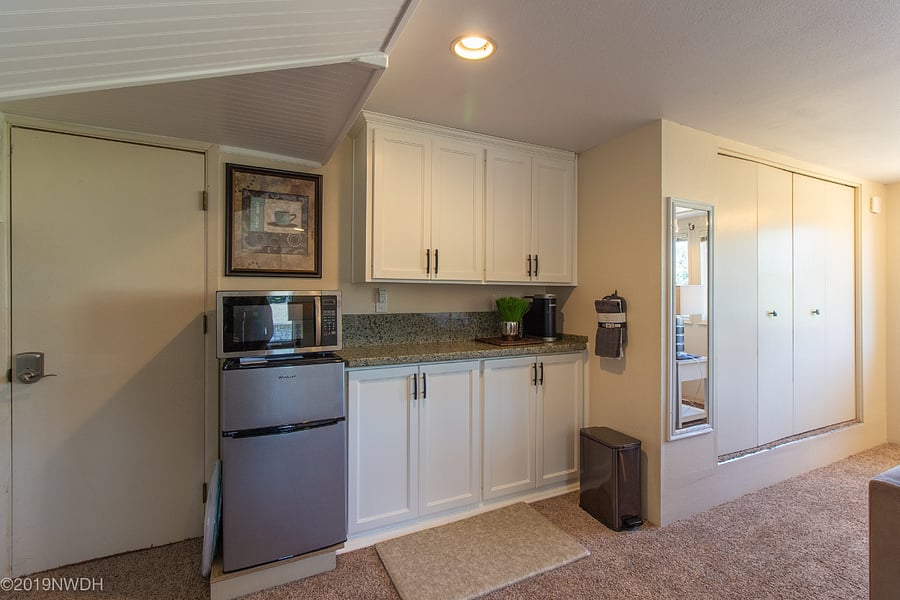 Storage cabinetry in kitchenette and adjacent closet