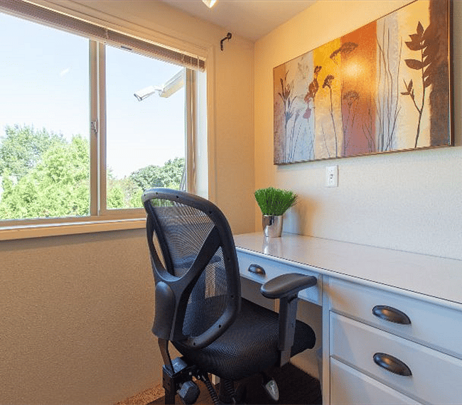 Office desk is well-lit by both interior and exterior light