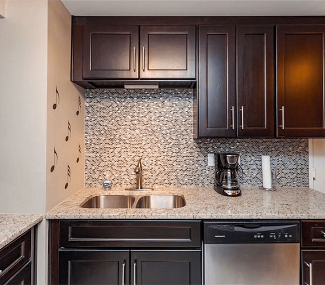 Kitchen with dishwasher, stove/oven, microwave and full size fridge