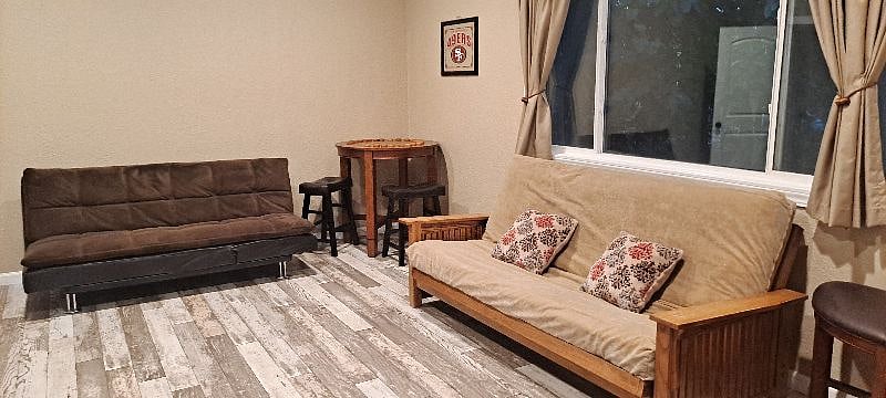 view looking back with fun checkers table and the 2 futons. BIG ROOM. no closet. sleeps 3
