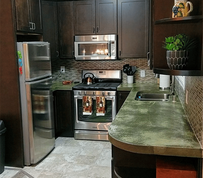 Left side of kitchen. Stainless steel appliances and beautiful cement counter tops