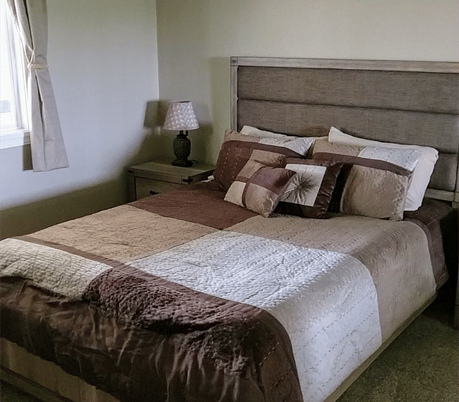 Queen size bed in bedroom and also a double closet with mirrored closet doors (not shown)