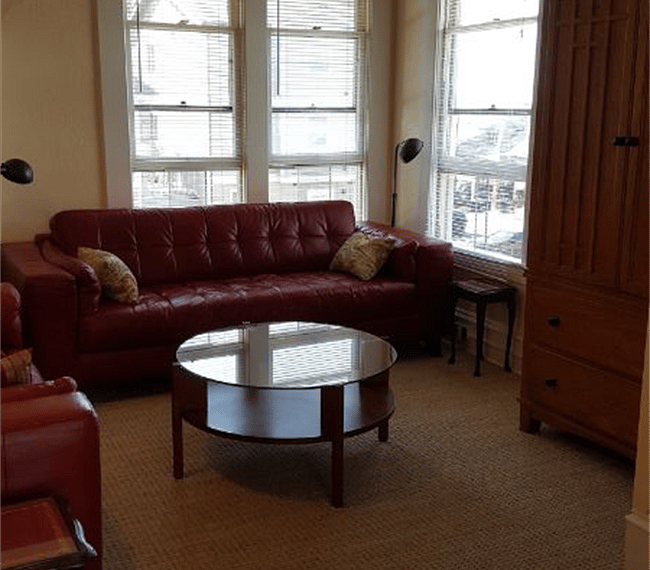 Living room, looking toward bay from kitchen.