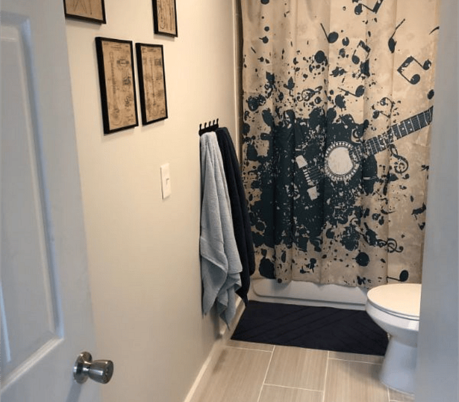 Private bathroom with tub and removable shower head.