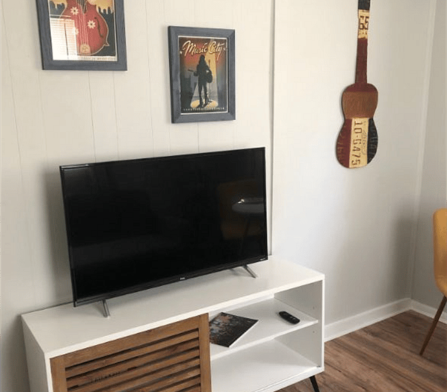 Front sitting room with HDTV and media console.