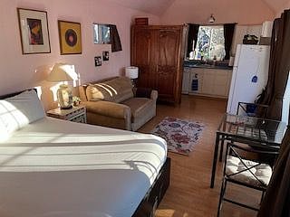 Queen bed, foldout sleeper loveseat, view into the kitchen