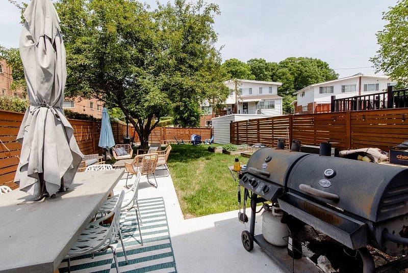 Large back yard with two grills and fire pit