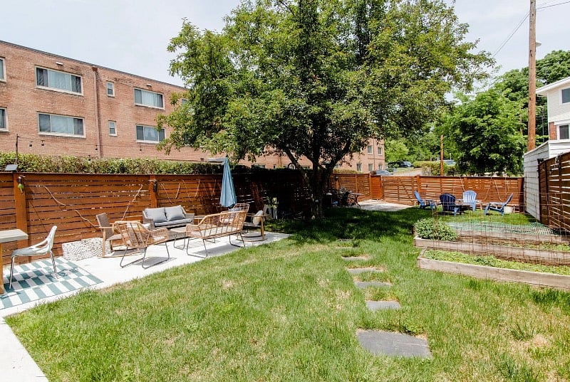 Large back yard with two grills and fire pit
