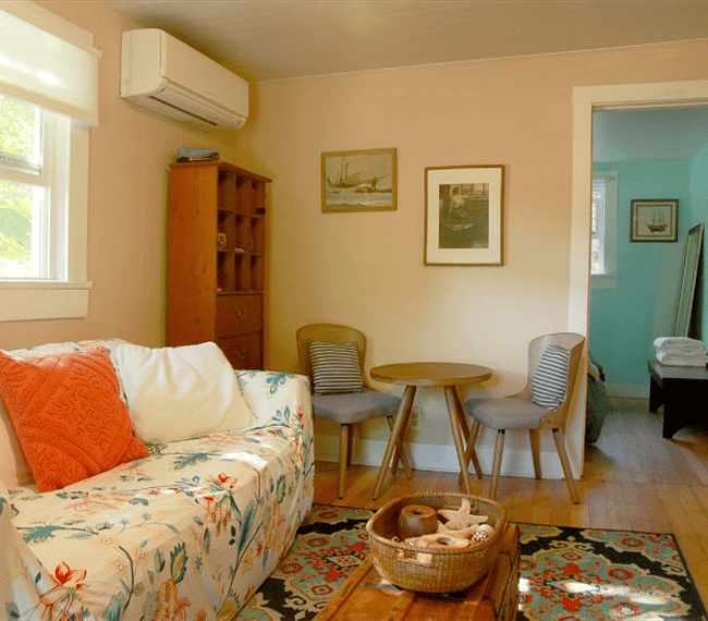 Living room with view into bedroom from front door vantage point.