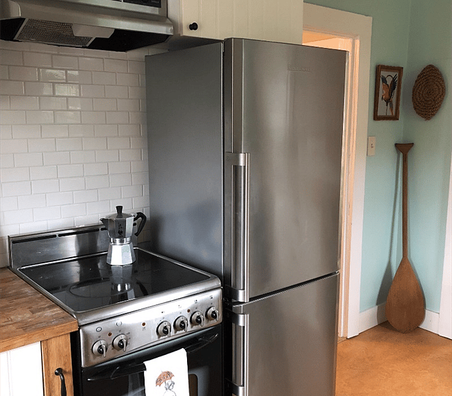 Oven with stove top and full size refrigerator.