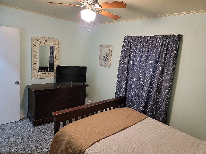 Front bedroom with double bed and tv