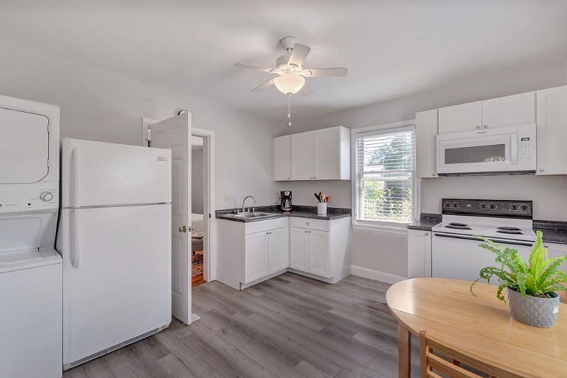 Full size fridge, stack washer & dryer, microwave exhaust, electric stove