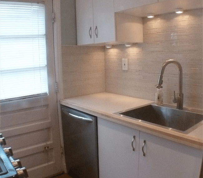 The kitchen has great under-counter lighting and gorgeous custom back-splash.