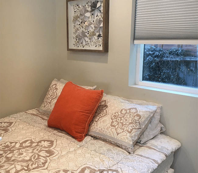 Queen bed, downstairs bedroom and window