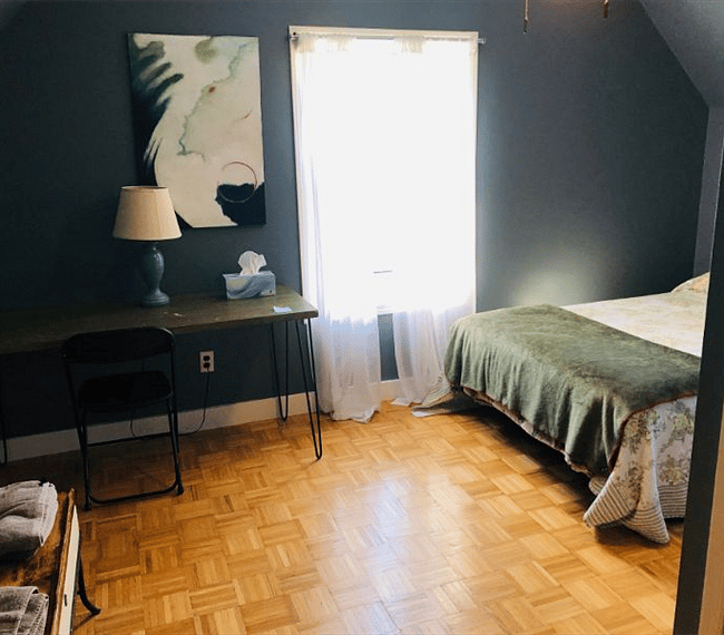 bedroom with door and ceiling fan - pictured here in summer