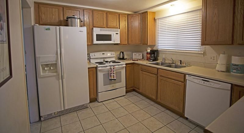 LARGE KITCHEN WITH DOUBLE DOOR REFRIGERATOR DISHWASHER, MICROWAVE AND ASSORTED SMALL APPLIANCE