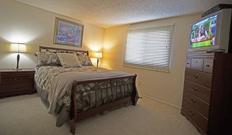 THIRD BEDROOM WITH OLYMPIC QUEEN BED, TV, AND BATHROOM NEARBY