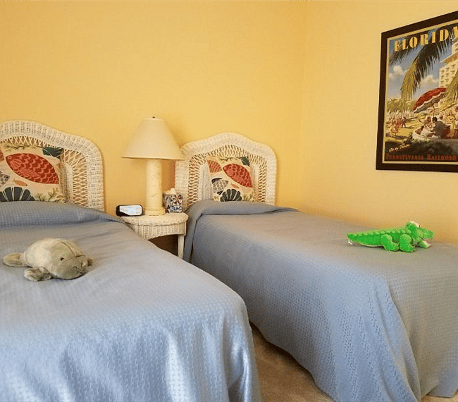 twin bedroom with tv and overhead fan