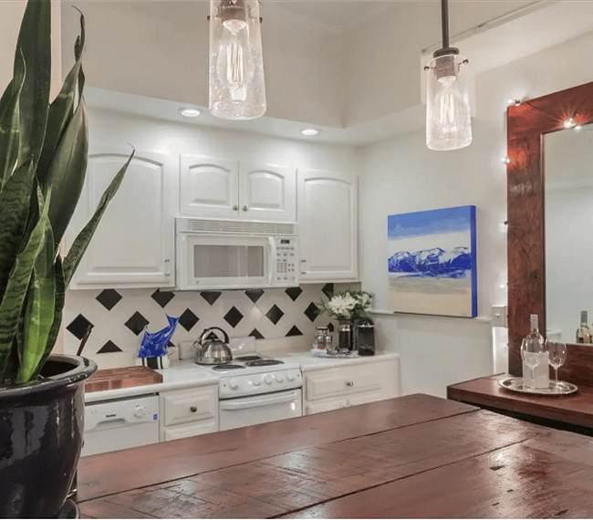Kitchen island where one can relax while the other cooks with ceiling fan