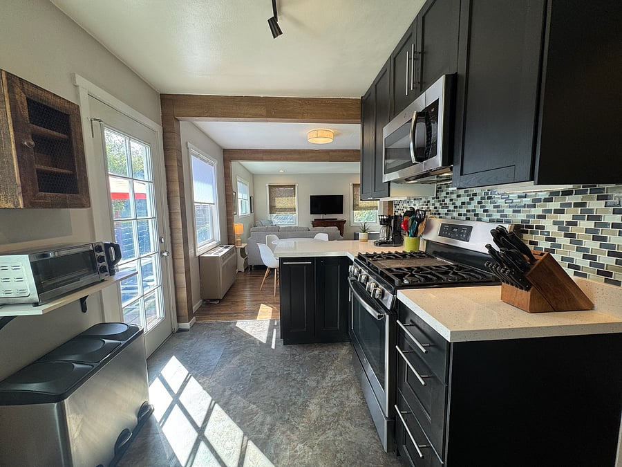 KITCHEN | Looking from kitchen to dining area and beyond to living room