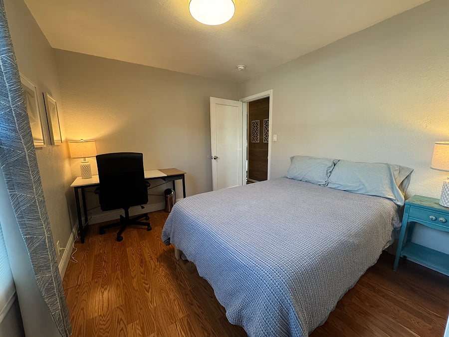 SECOND BEDROOM | Full bed, bedside table, walk-in closet with bins, desk & desk chair