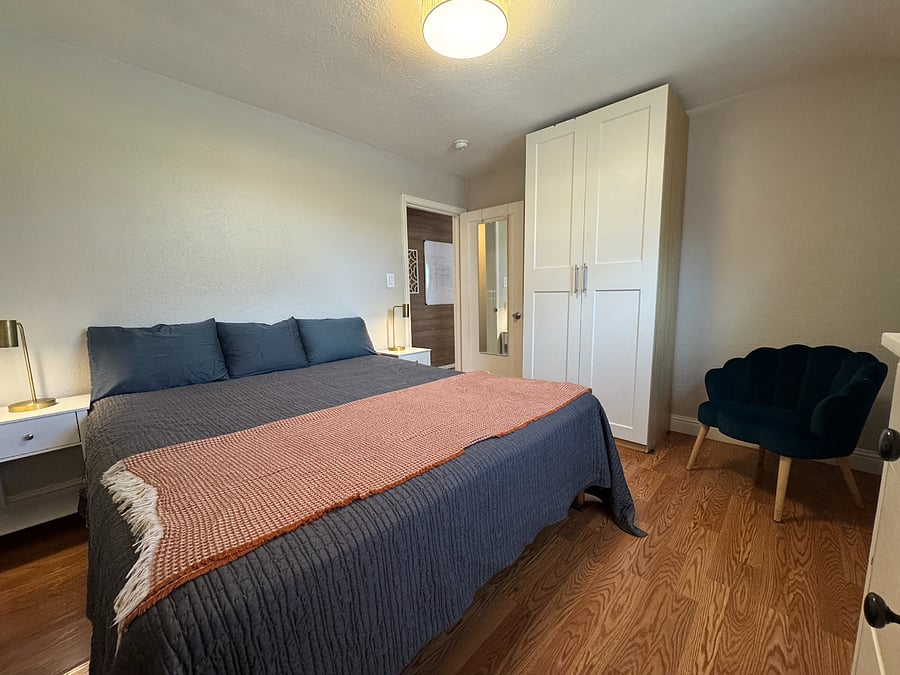 PRIMARY BEDROOM | Cal King bed, bedside tables, dresser & extra large armoire